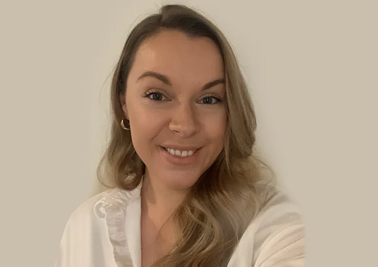 Smiling woman in white shirt.